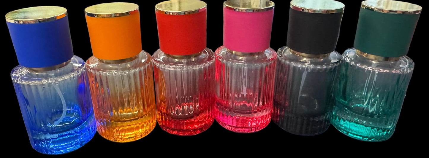 Set of colorful perfume bottles with multicolored caps on a desk.