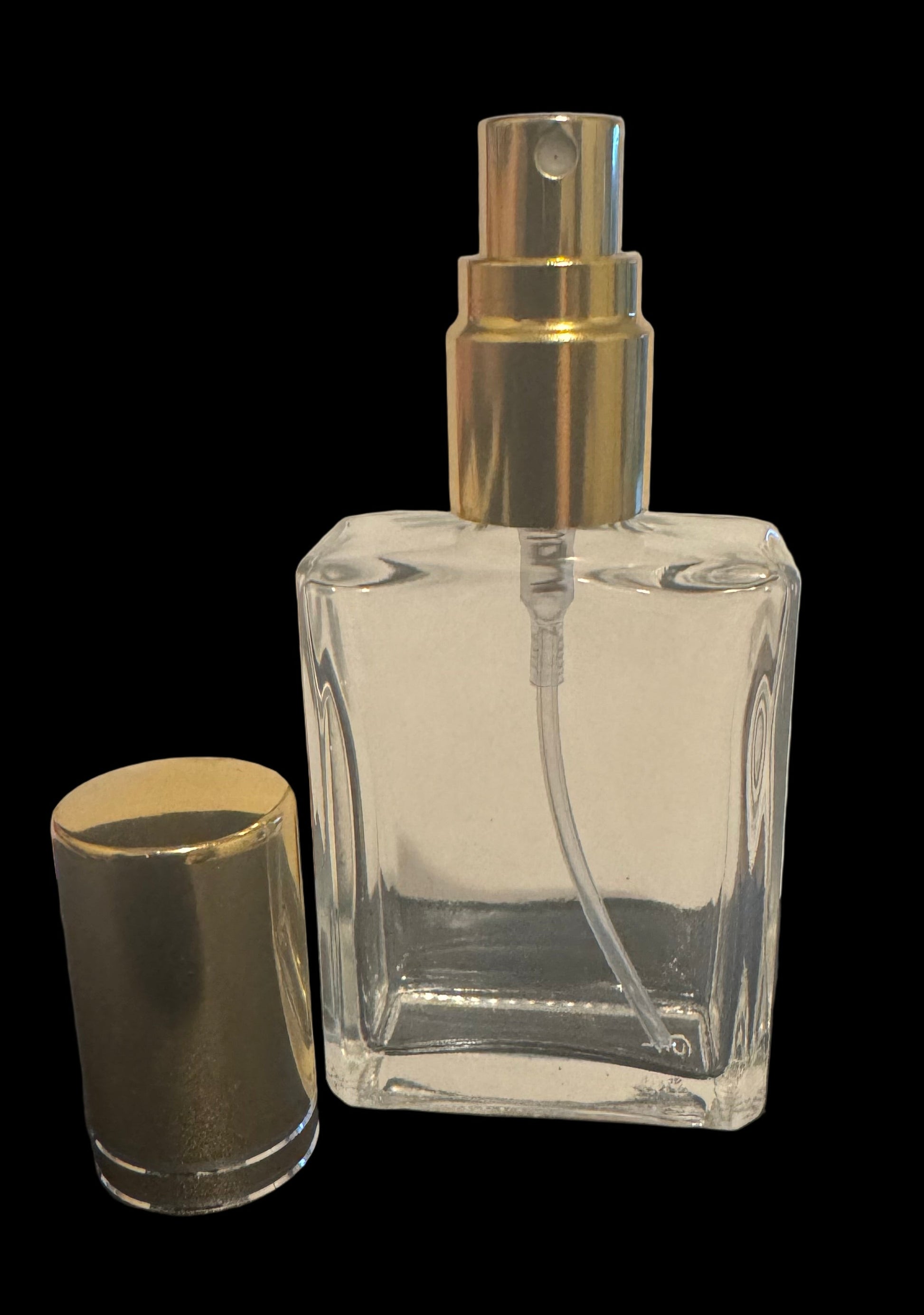 Clear glass perfume bottle with gold cap
