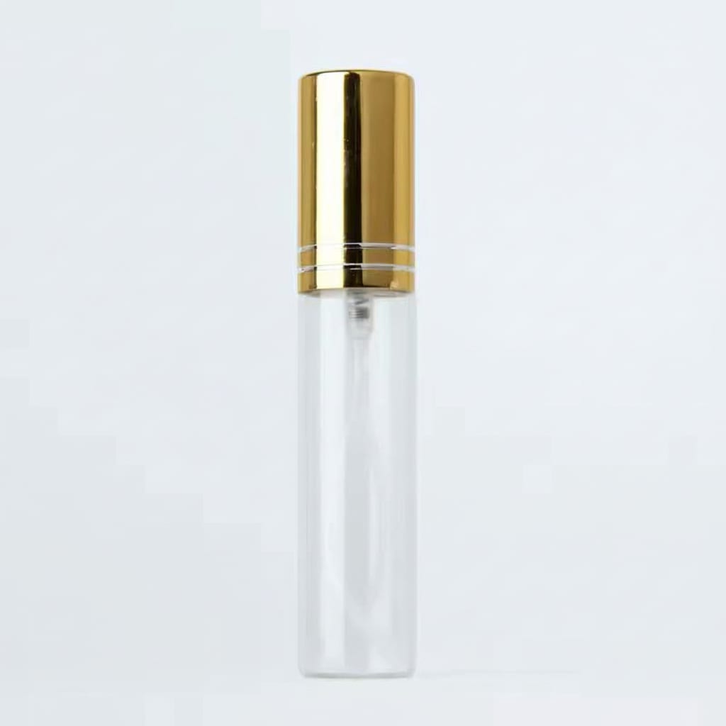 Clear bottle with gold cap on a light gray background