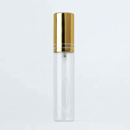 Clear bottle with gold cap on a light gray background