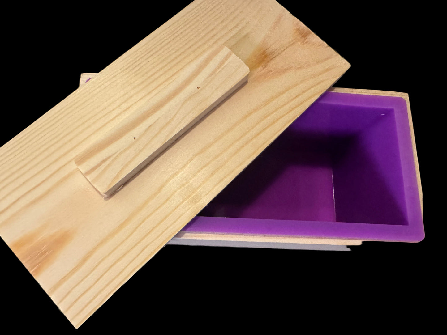 A Silicone and wood loaf soap mold with lid.